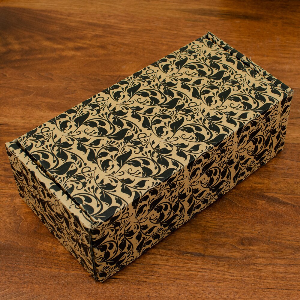 rectangle cardboard gift box with floral pattern on wooden table